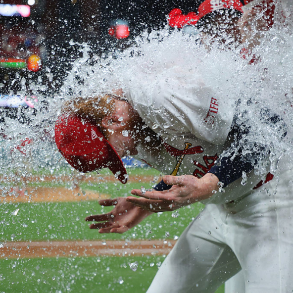 Dustin May of the Cardinals gets the water bucket dumped on him in celebration of his complete-game, one-hit, shutout victory over the Padres.