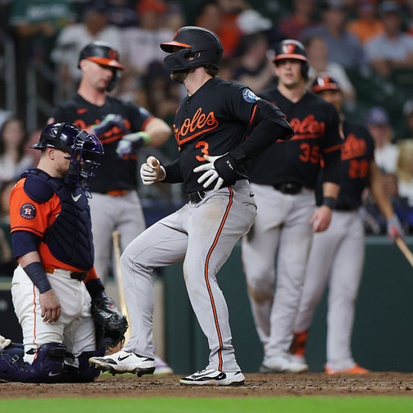 Taylor Ward of the Orioles scoring a run against the Astros