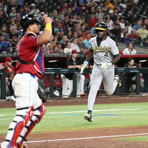 Lawrence Butler of the Athletics scoring a run against the Diamondbacks