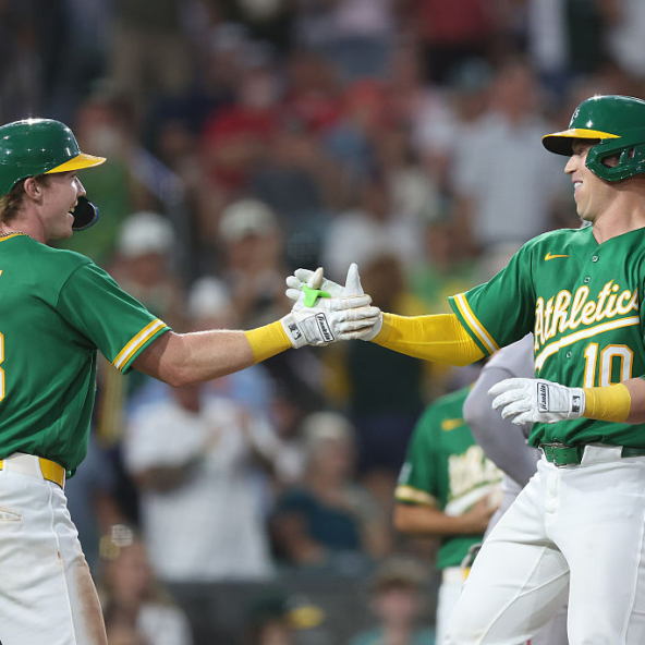 Brian Serven and Henry Bolte of the Athletics celebrating Serven's homer against the Red Sox
