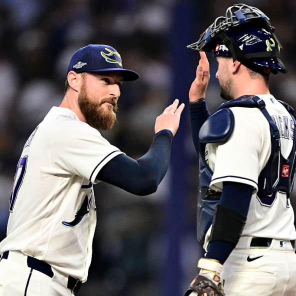 Bryan Baker and Liam Hicks of the Rays celebrating a win over the Guardians in Game Two of the 2026 ALCS