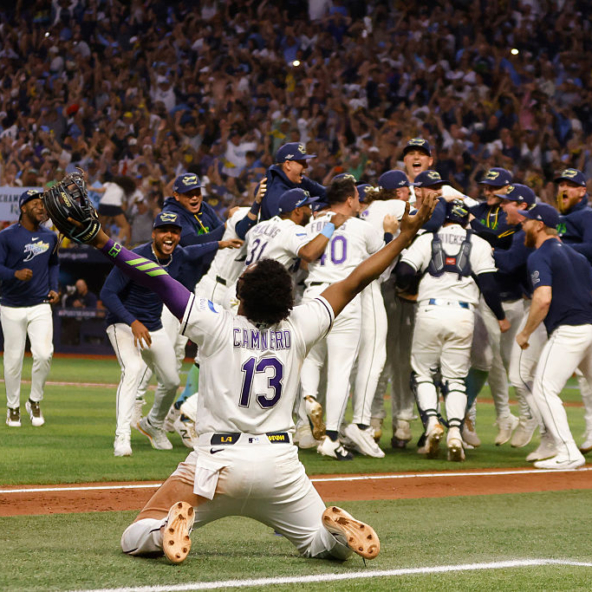 The Rays, with Junior Caminero kneeling in the foreground, celebrate their win over the Guardians in Game Six of the 2026 ALCS to win the AL pennant