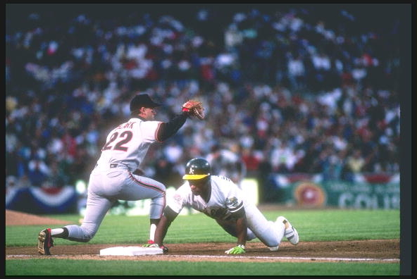 Rickey Henderson of the Oakland Athletics diving back to first as Will Clark of the San Francisco Giants catches the throw in the 1989 World Series. The foes have met annually in Interleague Play since 1997.