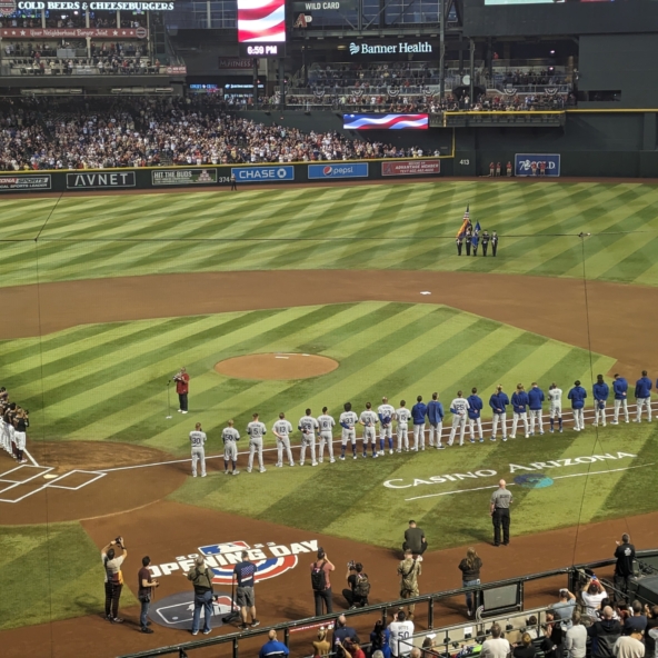 The Diamondbacks and Dodgers line up for the National Anthem after pregame festivities.