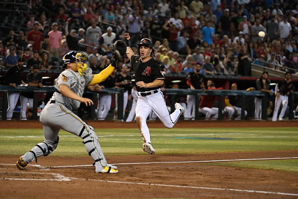 Jake McCarthy of the Diamondbacks sliding into home against the Brewers. The Diamondbacks face the Brewers on the road after taking two of three from the Guardians.