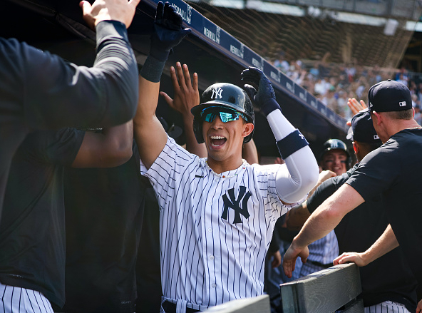 Oswaldo Cabrera of the New York Yankees slapping fives with teammates. The Yankees offense has performed well recently.