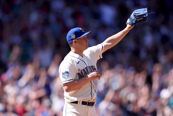 Seattle Mariners relief pitcher Paul Sewald stands between